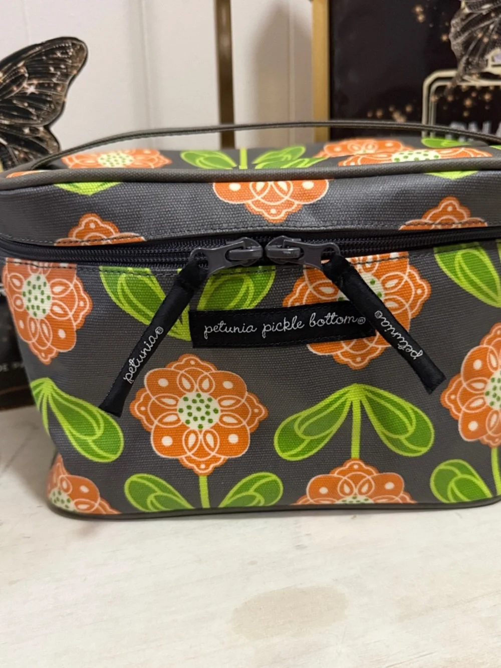 Petunia Pickle Bottom Gray Cosmetic Case with Orange Floral & Green Leaves